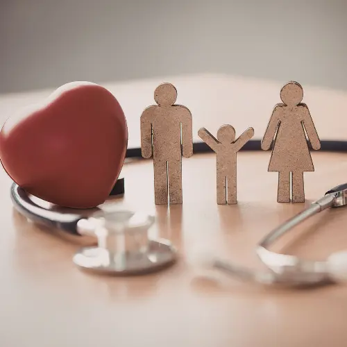 Wooden family cutouts and a stethoscope representing healthcare data management in Excel.