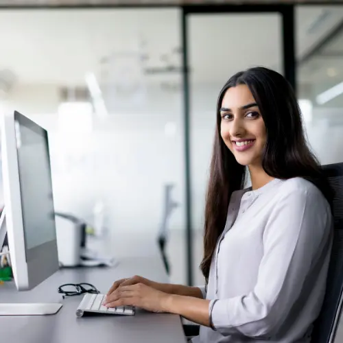Accountant happily reconciling financial statements using automated Excel macros.